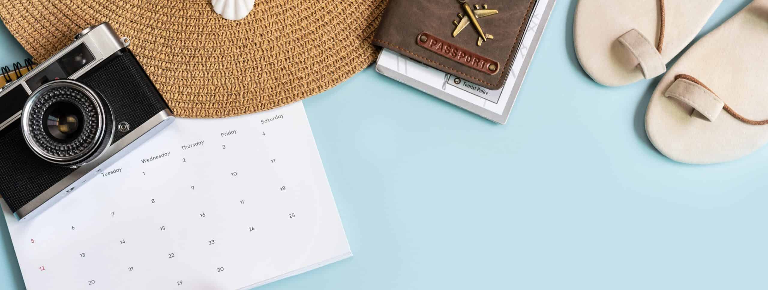 Blue layflat of a calendar, sun hat and passport